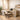 A stylish and compact spa studio setup featuring multi-functional furniture like a storage ottoman and a rolling cart, designed for the solo entrepreneur.