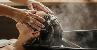 Woman receiving a luxurious hair spa treatment at a salon