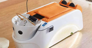 Woman receiving a relaxing Japanese head spa treatment on a modern shampoo bed