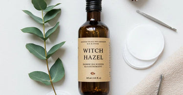 Witch hazel bottle and cotton pads for ingrown hair treatment in a spa setting