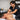 Massage therapist demonstrating proper ergonomic lunge stance and low table height while performing deep tissue work on a tall client
