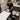 Technician demonstrating ergonomic body positioning for a full back waxing service with proper posture and table height adjustment