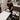 Technician demonstrating ergonomic body positioning for a full back waxing service with proper posture and table height adjustment