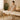 Therapist adjusting height of professional massage table in modern spa setting