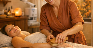 Professional spa dry brushing and clay mask application for fall detox body treatments