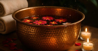 A sleek copper pedicure bowl with water and rose petals, showcasing its luxurious and hygienic design