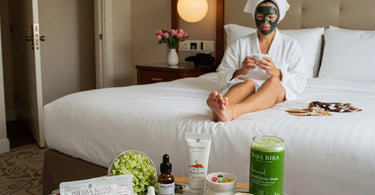 Luxury hotel spa amenities setup featuring robes, towels, and wellness products on a bed