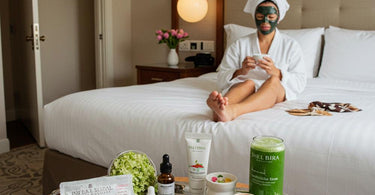 Luxury hotel spa amenities setup featuring robes, towels, and wellness products on a bed