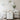 Spa treatment room stocked with professional supplies including cotton rounds, waxing tools, massage oils, and rolling carts