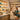 A beautifully organized spa retail shelf displaying skincare products next to a professional massage treatment area with towels and equipment, illustrating the difference between front bar retail and back bar service products.
