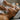 Gua Sha tool on a spa towel with skincare products in the background