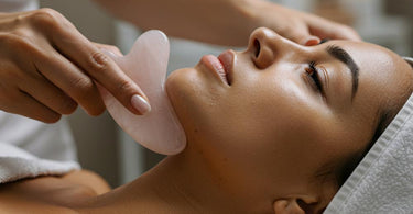 Gua Sha tool on a spa towel with skincare products in the background
