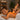 Pink Himalayan salt massage stones arranged on bamboo tray for spa treatments