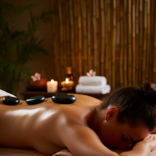 Hot stone massage therapy in a spa setting, showcasing basalt stones and a relaxing ambiance