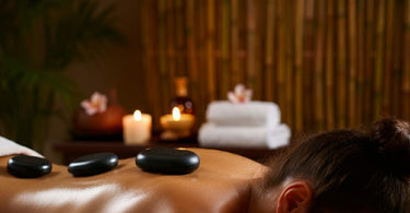 Hot stone massage therapy in a spa setting, showcasing basalt stones and a relaxing ambiance