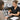 Client using an at-home beauty device while a salon professional explains how home technology affects retention and treatment planning