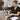 Client using an at-home beauty device while a salon professional explains how home technology affects retention and treatment planning