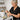 Waxing professional demonstrating the correct directional pull for underarm waxing using hard wax and a wooden spatula