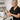 Waxing professional demonstrating the correct directional pull for underarm waxing using hard wax and a wooden spatula