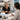 A spa therapist gracefully hands a tablet to a smiling client, illustrating a comfortable and non-pressuring way to ask for a review in a professional beauty setting.