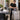 Professional salon and spa linens organized for end-of-day laundry handoff with towel steamer and rolling hampers