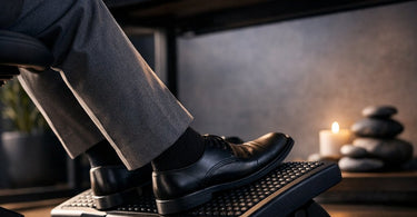 A professional massage therapist using an ergonomic footrest at a spa station to prevent fatigue and improve posture.