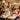 A bright and modern nail salon featuring a sleek, curved manicure table where a technician and client are engaged in a lively conversation, highlighting the social aspect of the service.