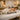 An assortment of professional massage bolsters and pillows in different shapes and sizes, including cylindrical, crescent, and wedge styles, neatly arranged on a massage table for optimal client support.