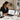 Woman looking at scheduling software on tablet in a spa setting with massage table and towels