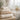 A luxurious stack of fluffy white spa towels and bath sheets of different sizes and weights, neatly folded in a serene spa treatment room