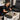 A professional pedicure tub with a focus on a removable filter screen being cleaned with a small brush and a disinfectant spray, emphasizing salon hygiene and equipment maintenance.