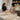 A serene spa treatment room set up for a prenatal massage with a portable massage table, bolsters, and soft ambient lighting.