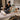 A serene spa treatment room setup for prenatal massage, featuring a massage table with supportive bolsters and pillows, soft ambient lighting, and pregnancy-safe products.