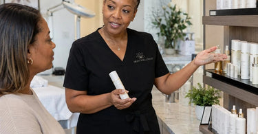 A serene spa treatment room transitioning to a beautifully curated retail area with skincare products and professional spa supplies.