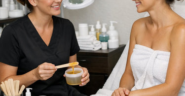 A serene spa client receiving a warm towel ritual on a luxurious spa bed, symbolizing emotional connection and relaxation.
