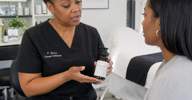 Professional stylist recommending take-home hair care products to a client in a salon, illustrating how to explain products without sounding salesy.