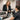 A compassionate spa manager having a private, respectful termination conversation with a staff member in a sunlit office.