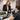 A compassionate spa manager having a private, respectful termination conversation with a staff member in a sunlit office.