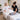 Massage therapist adjusting a bolster under a client's knees on a professional massage table to improve comfort during a spa treatment