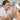 Esthetician examining client's skin with magnifying lamp during a facial treatment consultation