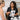 Therapist using a professional percussion massage tool on a client's back during a Swedish massage treatment at a spa.