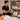A professional massage therapist adjusting a bottle warmer with massage oils, ensuring client comfort and warm products.