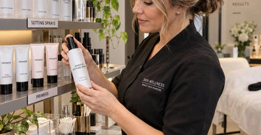 Organized salon station with labeled setting sprays and primers in clear acrylic storage