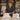 A spa professional gently folds a plush white spa robe, readying it for the next guest. The image promotes a guide on keeping spa robes looking guest-ready longer.
