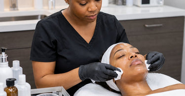 Professional aesthetician applying a neutralizing solution to a client&rsquo;s face after a glycolic peel treatment in a spa setting.