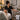 Spa professional offering a glass of infused water to a relaxed client on a massage table in a serene treatment room