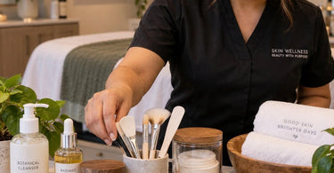 A beautifully styled spa treatment room with professional tools like facial steamer, massage table, and wax warmer, elegantly arranged to look luxurious and inviting rather than clinical.