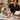 A beautifully styled spa treatment room with professional tools like facial steamer, massage table, and wax warmer, elegantly arranged to look luxurious and inviting rather than clinical.