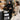 Spa professional arranging supplies at proper height to reduce shoulder strain
