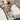 A serene and well-appointed spa room featuring two side-by-side facial beds, prepared for a couples or tandem facial treatment, with ambient lighting and all necessary equipment.
